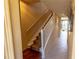 Interior stairway showcasing carpeted steps, white railing, and neutral wall colors at 3244 Mangrove Point Dr, Ruskin, FL 33570