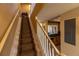 Carpeted stairway leading upstairs with white railings and adjacent to the kitchen area at 3244 Mangrove Point Dr, Ruskin, FL 33570