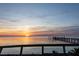 Sunset view with calm water, dock extending into the tranquil waters, and colorful skyline at 3244 Mangrove Point Dr, Ruskin, FL 33570