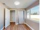 Bedroom featuring wood floors, a large window overlooking the backyard, and a closet at 3350 Brookfield Dr, Holiday, FL 34691