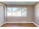 Cozy bedroom with wood floors, a large window, and a closet with sliding doors at 3350 Brookfield Dr, Holiday, FL 34691