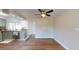 Dining area with hardwood floors adjacent to the kitchen, featuring stainless steel appliances and granite counters at 3350 Brookfield Dr, Holiday, FL 34691