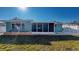 Rear exterior of home featuring blue paint, new window, and landscaped yard at 3350 Brookfield Dr, Holiday, FL 34691