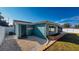 Rear exterior of home featuring blue paint, new window, and landscaped yard at 3350 Brookfield Dr, Holiday, FL 34691