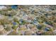 An aerial view of homes in a suburban neighborhood with mature trees and a community lake at 3704 Thornwood Pl, Tampa, FL 33618