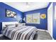 This bedroom features bold paint, striped bedding and a closet at 3704 Thornwood Pl, Tampa, FL 33618