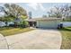 Well-maintained home featuring a long driveway leading to an attached two-car garage at 3704 Thornwood Pl, Tampa, FL 33618