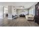 Inviting living room with gray walls, modern flooring, large window with shutters and a ceiling fan at 3704 Thornwood Pl, Tampa, FL 33618