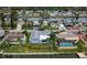 Aerial view of waterfront houses with tropical landscaping and pools at 3832 Star Island Dr, Holiday, FL 34691