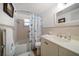 Cozy bathroom featuring seashell-themed shower curtain and a white vanity at 3832 Star Island Dr, Holiday, FL 34691