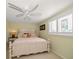 Serene bedroom featuring a ceiling fan, bright window, and comfortable furnishings for a relaxing space at 3832 Star Island Dr, Holiday, FL 34691