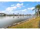 Waterfront view from the backyard featuring a serene canal and neighboring docks at 3832 Star Island Dr, Holiday, FL 34691