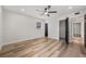 Spacious bedroom with wood-look floors, ceiling fan, and large closet at 4412 W Pearl Ave, Tampa, FL 33611