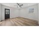 Bright bedroom with wood-look floors, ceiling fan, and exterior access at 4412 W Pearl Ave, Tampa, FL 33611