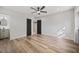 Light-filled bedroom with wood-look floors, ceiling fan, and ensuite bath at 4412 W Pearl Ave, Tampa, FL 33611