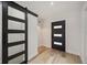 Modern entryway with barn door leading to laundry room at 4412 W Pearl Ave, Tampa, FL 33611