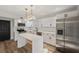 Modern white kitchen with stainless steel appliances and quartz countertops at 4412 W Pearl Ave, Tampa, FL 33611