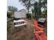 Backyard with detached shed and outdoor seating offers space for relaxation and entertainment at 4425 Autumn Palm Dr, Zephyrhills, FL 33542