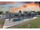 Backyard with an in-ground pool with a -proof safety fence and open patio at 4440 Huntington Ne St, St Petersburg, FL 33703