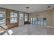 Sunlit living area featuring tile floors, paneled walls, and a patio door, requiring renovation at 4440 Huntington Ne St, St Petersburg, FL 33703