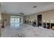 Unfinished living room features a ceiling fan, tile floors, and an open layout, ready for renovation at 4440 Huntington Ne St, St Petersburg, FL 33703