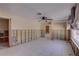 Spacious living area featuring tile floors, a ceiling fan, and paneled walls awaiting renovation at 4440 Huntington Ne St, St Petersburg, FL 33703