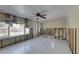 Spacious living area featuring tile floors, a ceiling fan, and paneled walls awaiting renovation at 4440 Huntington Ne St, St Petersburg, FL 33703