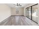 Bedroom with light walls, modern ceiling fan, and sliding glass doors leading to the outdoors at 4472 Bayridge Ct, Spring Hill, FL 34606