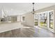 Dining room area with updated floors and bright bay windows at 4472 Bayridge Ct, Spring Hill, FL 34606