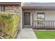 Close up of the front porch and door, with brick detail and manicured landscaping at 4472 Bayridge Ct, Spring Hill, FL 34606