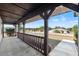 Covered front porch featuring wood railings, ample space, and neighborhood views at 4472 Bayridge Ct, Spring Hill, FL 34606