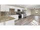 Well-lit kitchen featuring white cabinets, stainless steel appliances, and modern backsplash at 4472 Bayridge Ct, Spring Hill, FL 34606