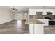 Inviting living area flows to kitchen with wood-look flooring and natural light from window at 4472 Bayridge Ct, Spring Hill, FL 34606