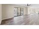 Bright living room featuring modern ceiling fan, and sliding glass doors leading to the outdoors at 4472 Bayridge Ct, Spring Hill, FL 34606