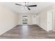 Living room with neutral walls, stylish ceiling fan, and natural lighting at 4472 Bayridge Ct, Spring Hill, FL 34606