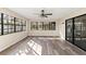 Bright sun room with large windows, sliding door, and stylish flooring at 4472 Bayridge Ct, Spring Hill, FL 34606