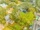 Aerial perspective of property displaying backyard pool, shed, mature trees, and surroundings at 4636 W Longfellow Ave, Tampa, FL 33629