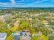 An aerial view of lush green trees and homes on a sunny day, showcasing community and landscape at 4636 W Longfellow Ave, Tampa, FL 33629