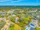 A neighborhood aerial view featuring lush greenery and a home with mature trees and potential for a peaceful setting at 4636 W Longfellow Ave, Tampa, FL 33629