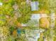 Aerial view of property highlighting home, pool, mature trees, and neighborhood at 4636 W Longfellow Ave, Tampa, FL 33629