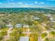 Aerial view of a residential neighborhood showcasing the location with tree-lined streets and varied homes, and proximity to water at 4636 W Longfellow Ave, Tampa, FL 33629