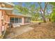 The backyard shows a patio area, a screened in porch, and mature landscaping, offering relaxation and outdoor enjoyment at 4636 W Longfellow Ave, Tampa, FL 33629