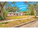 Charming pink single-story home with mature landscaping, and a long private driveway at 4636 W Longfellow Ave, Tampa, FL 33629