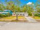 Lovely single-story home with a driveway, complemented by mature trees and landscaping at 4636 W Longfellow Ave, Tampa, FL 33629