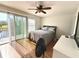 Bedroom with a queen-size bed, ceiling fan, and access to balcony at 4883 Tuscan Loon Dr, Tampa, FL 33619