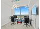 Bright home office features a large window with water views, two desks, and modern chairs at 5120 Marina Way # 14002, Tampa, FL 33611