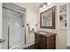 Well-lit bathroom featuring a glass-enclosed shower and carved wood vanity at 5265 E Bay Dr # 424, Clearwater, FL 33764