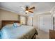 Relaxing bedroom featuring a ceiling fan, neutral decor, and ample closet space at 5265 E Bay Dr # 424, Clearwater, FL 33764