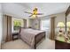 Sunlit bedroom featuring neutral colors, carpet, and two bright windows at 5265 E Bay Dr # 424, Clearwater, FL 33764