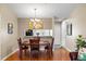 Dining area featuring hardwood floors, light-colored walls, and a passthrough to the kitchen at 5265 E Bay Dr # 424, Clearwater, FL 33764